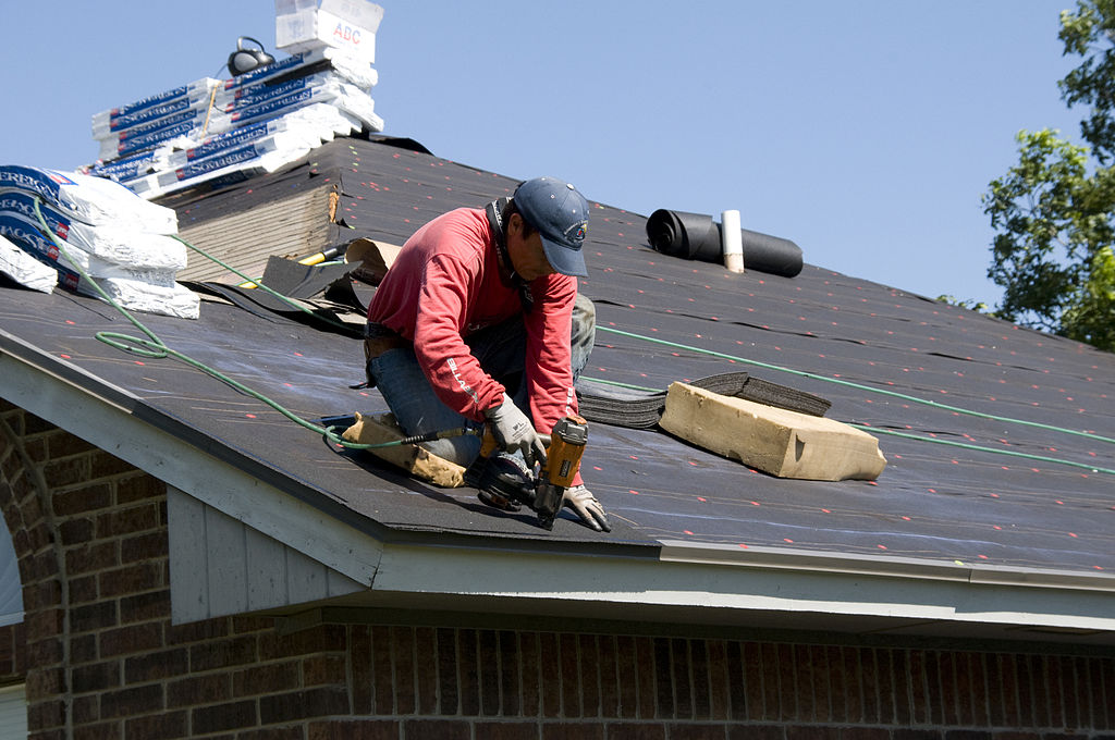 man installing a roof
